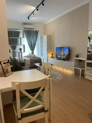 a living room with a table and a couch at Stay Calm in Athens