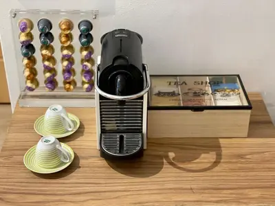 a toaster sitting on top of a table next to plates at Stay Calm in Athens