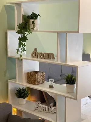a white shelf with potted plants on it at Stay Calm in Athens