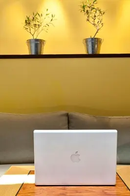 a laptop sitting on a table in front of a couch at Arion Athens Hotel in Athens