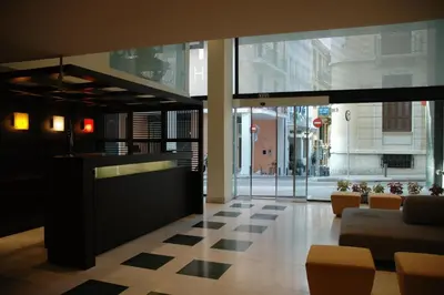 a lobby with a checkered floor in a building at Hermes Hotel in Athens