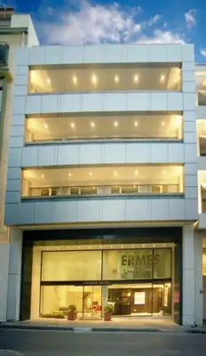 a large white building with the name of a store at Hermes Hotel in Athens