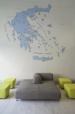a map of europe on a wall with a couch at Hermes Hotel in Athens
