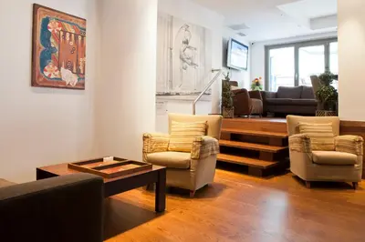 a living room with two chairs and a table at Plaka Hotel in Athens