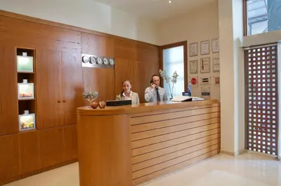 two women standing at a counter in a salon at Plaka Hotel in Athens