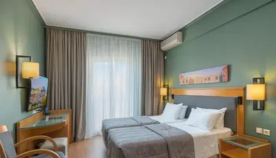 a hotel room with a bed and a window at Plaka Hotel in Athens