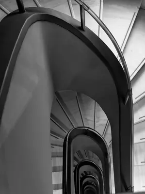 a black and white photo of a spiral staircase at Hotel Achilleas in Athens