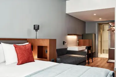a bedroom with a bed and a couch and a desk at Hotel Achilleas in Athens