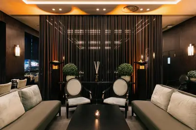a lobby with couches and a table with plants at Divani Caravel in Athens