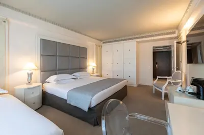 a hotel room with a large bed and a bathroom at NJV Athens Plaza in Athens