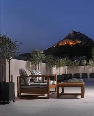 two wooden benches and a table and a mountain at NJV Athens Plaza in Athens