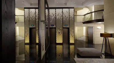 a hallway with two glass doors and a staircase at NJV Athens Plaza in Athens