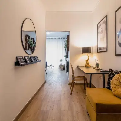 a living room with a table and a mirror at Classy Apartment in Athens in Athens