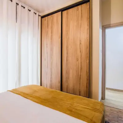 a bedroom with a bed with a wooden closet at Classy Apartment in Athens in Athens