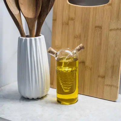 a bottle of oil next to a vase with wooden spoons at Classy Apartment in Athens in Athens