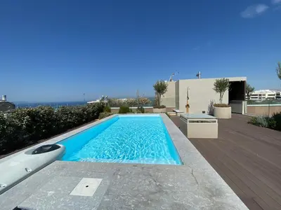 a swimming pool in the backyard of a house at Athens Riviera 2-Bed Apt & Pool Access #Unoblu® in Athens