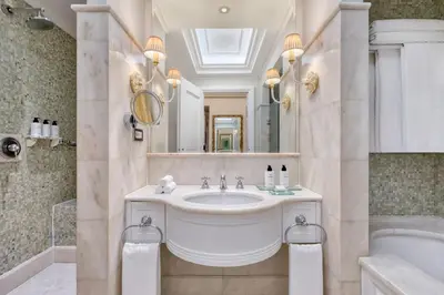 a bathroom with a sink and a tub and a mirror at King George, a Luxury Collection Hotel, Athens in Athens