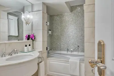 a white bathroom with a tub and a sink at King George, a Luxury Collection Hotel, Athens in Athens