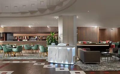 a lobby with chairs and tables and a bar at Crowne Plaza Athens City Centre by IHG in Athens