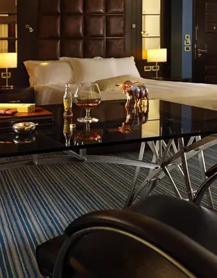 a bedroom with a bed and a table with wine glasses at Crowne Plaza Athens City Centre by IHG in Athens