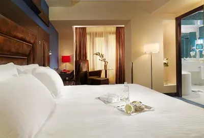 a hotel room with a white bed with a tray on it at Crowne Plaza Athens City Centre by IHG in Athens