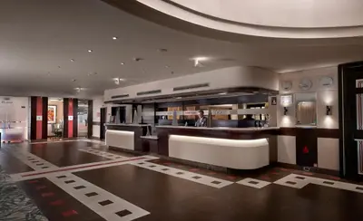 a lobby of a building with a man standing in it at Crowne Plaza Athens City Centre by IHG in Athens