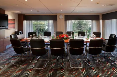 a conference room with a long table and chairs at Crowne Plaza Athens City Centre by IHG in Athens