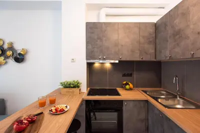 a kitchen with a wooden counter top with a sink at Blue Ark Boho Stay at Acropolis in Athens