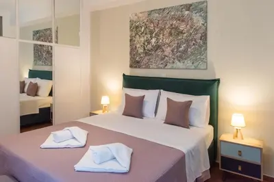 a bedroom with a large bed with two towels on it at Blue Ark Boho Stay at Acropolis in Athens