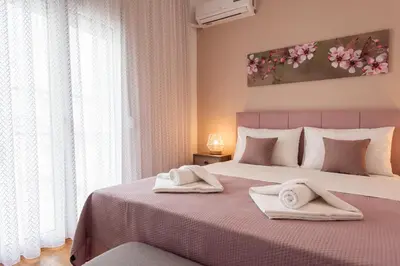 a bedroom with a large bed with two towels on it at Blue Ark Boho Stay at Acropolis in Athens