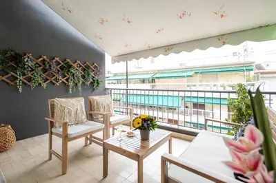 a balcony with a table and chairs and a large window at Blue Ark Boho Stay at Acropolis in Athens