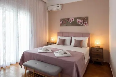 a bedroom with a large bed with two towels on it at Blue Ark Boho Stay at Acropolis in Athens