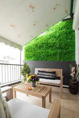 a patio with a bench and a green wall at Blue Ark Boho Stay at Acropolis in Athens