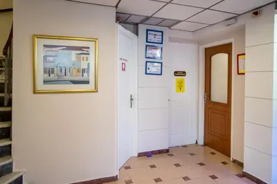 a hallway with a door and a picture on a wall at Anita Hotel in Piraeus