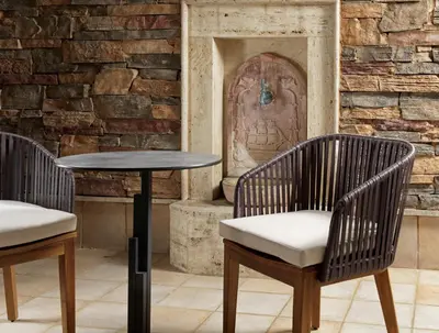 two chairs and a table in front of a brick wall at Holiday Suites in Athens