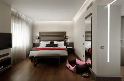 a hotel room with a bed and a mirror at Holiday Suites in Athens