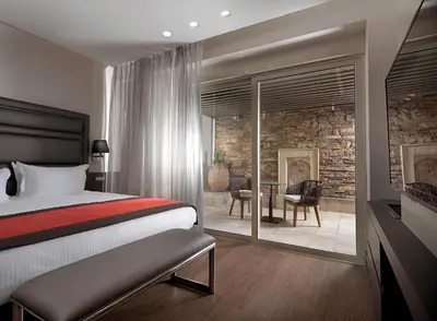 a bedroom with a bed and a table with chairs at Holiday Suites in Athens