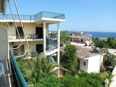 a view of a building with a balcony at Hotel Karyatides in Agia Marina Aegina