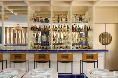 a bar at a restaurant with tables and chairs at Ace Hotel & Swim Club Athens in Athens