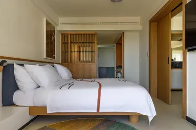a bedroom with a large white bed with white pillows at Ace Hotel & Swim Club Athens in Athens