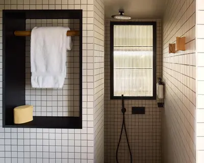 a bathroom with a mirror and a towel at Ace Hotel & Swim Club Athens in Athens
