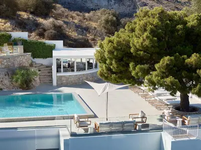 a swimming pool with lounge chairs and a tree at The Roc Club, A Grecotel Hotel to Live in Athens