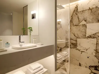 a bathroom with a sink and a mirror at The Roc Club, A Grecotel Hotel to Live in Athens