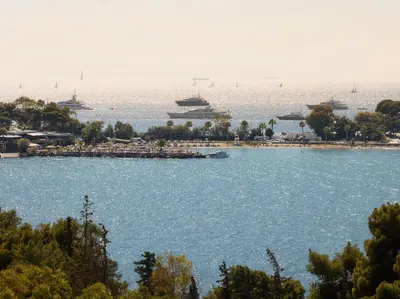 a view of a harbor with ships in the water at The Roc Club, A Grecotel Hotel to Live in Athens
