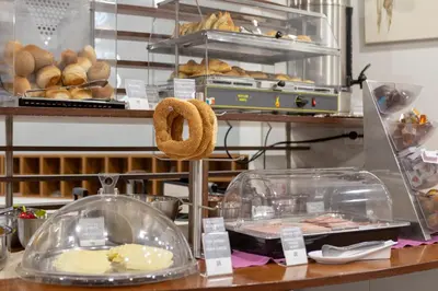 a bakery with a counter with pastries and bread at Pan Hotel in Athens