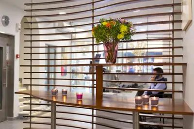 a table with a vase of flowers on top of it at Pan Hotel in Athens
