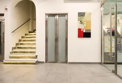 a hallway with stairs and a door in a building at Pan Hotel in Athens