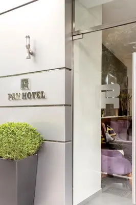 a door to a rain house with a plant next to it at Pan Hotel in Athens