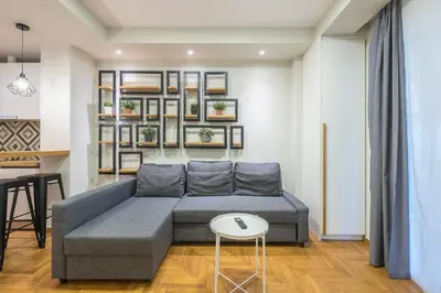 a living room with a couch and a table at Pame Rentals - Walk Distance To Acropolis with A Charming Design in Athens