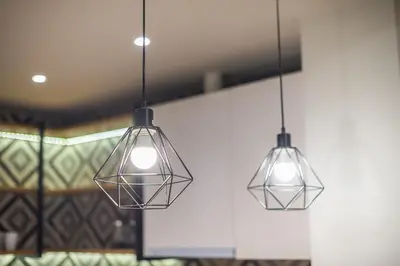 two lights hanging from the ceiling in a room at Pame Rentals - Walk Distance To Acropolis with A Charming Design in Athens